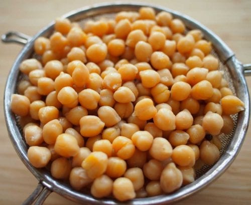 Sieve full of cooked chickpeas/garbanzos