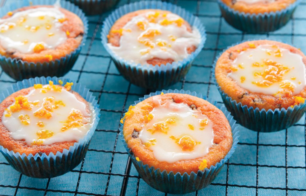 Orange choc-chip muffins with orange icing