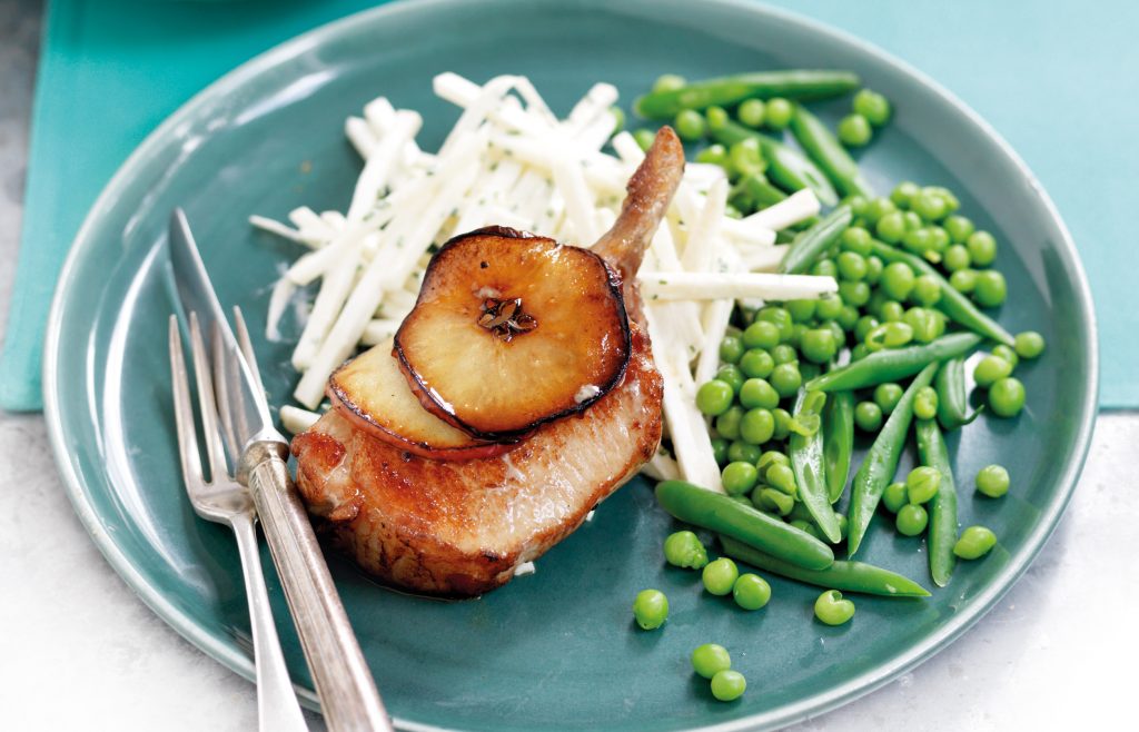 Pork cutlets with sliced red apple and maple syrup