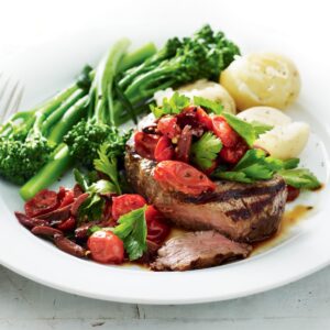 Steak with tomato, olive and parsley relish