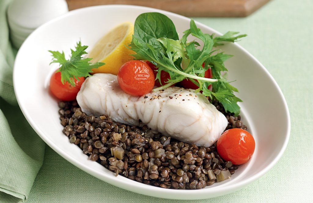 Baked fish with roasted tomatoes and lentils