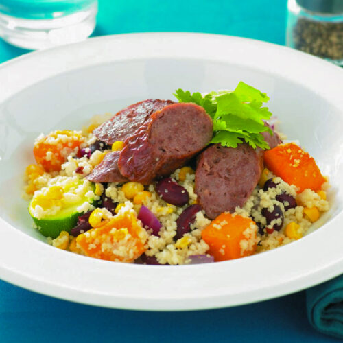 Baked vegetable couscous with sausages