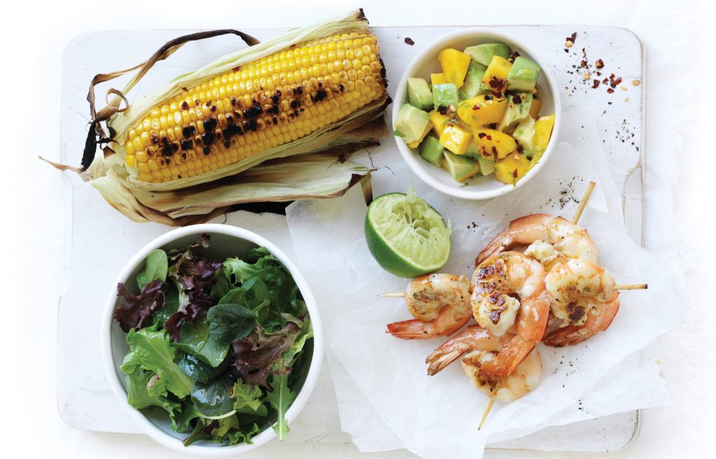 Barbecued prawn skewers with corn and mango chilli salsa
