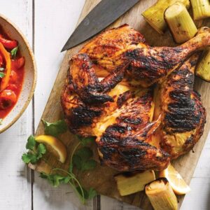 Butterflied harissa chicken with barbecued leek and lemon pepper sauce