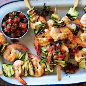 Prawn skewers with lemon, caper and tomato dressing