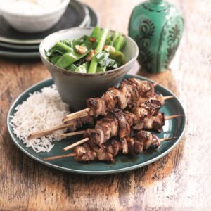 Asian grilled pork skewers with garlic greens