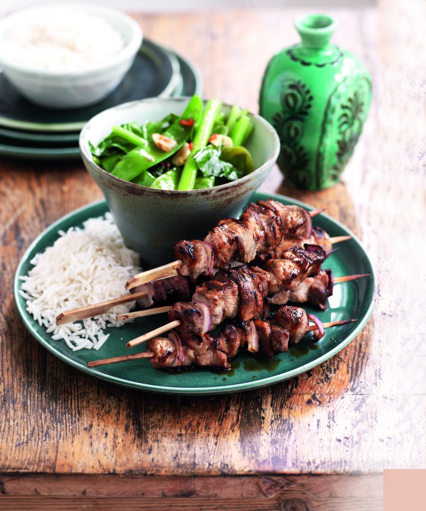 Asian grilled pork skewers with garlic greens