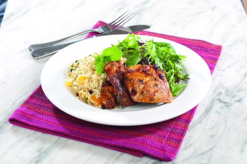 Grilled spiced chicken on fruity couscous