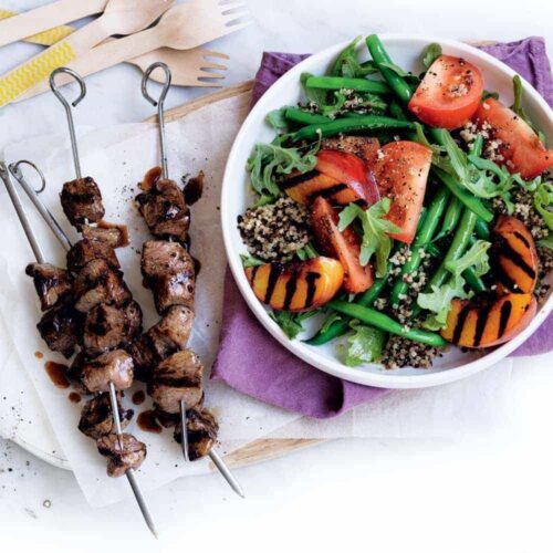 Lamb skewers with peach and quinoa salad