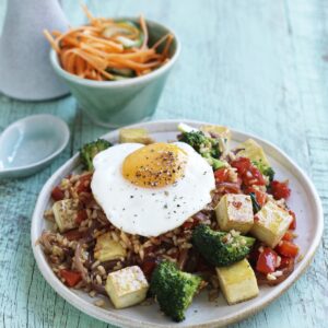 Nasi goreng with fried egg, pickled cucumber and carrot