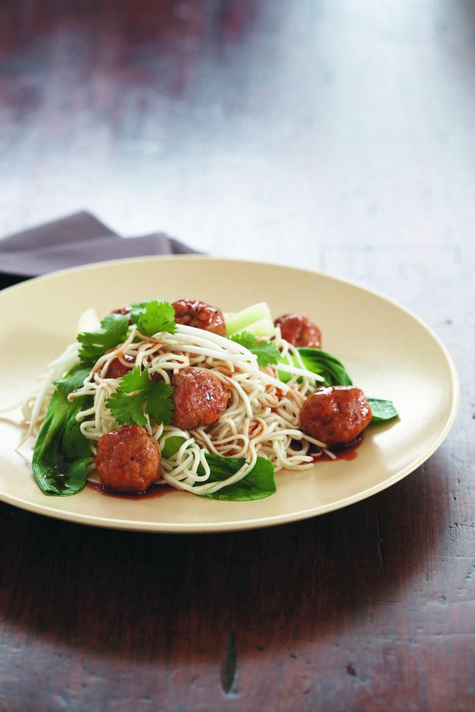 Pork meatballs with egg noodles and Asian greens
