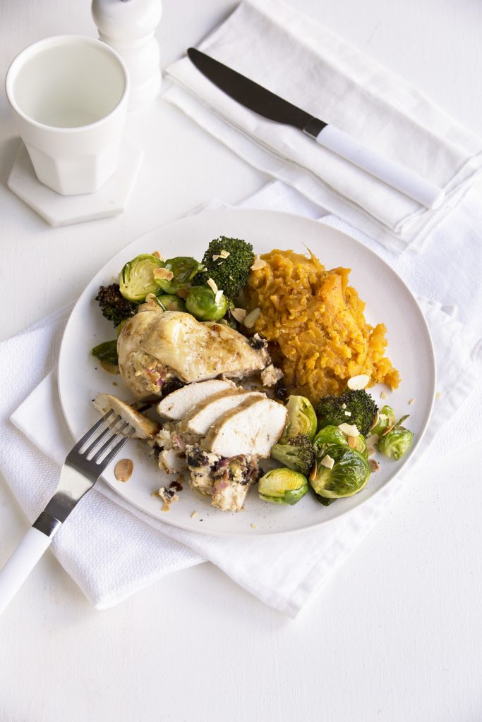 Prune and cream cheese-stuffed chicken breast with roasted greens and toasted almonds