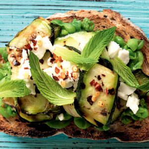 Smashed pea, courgette, feta and mint toast topper