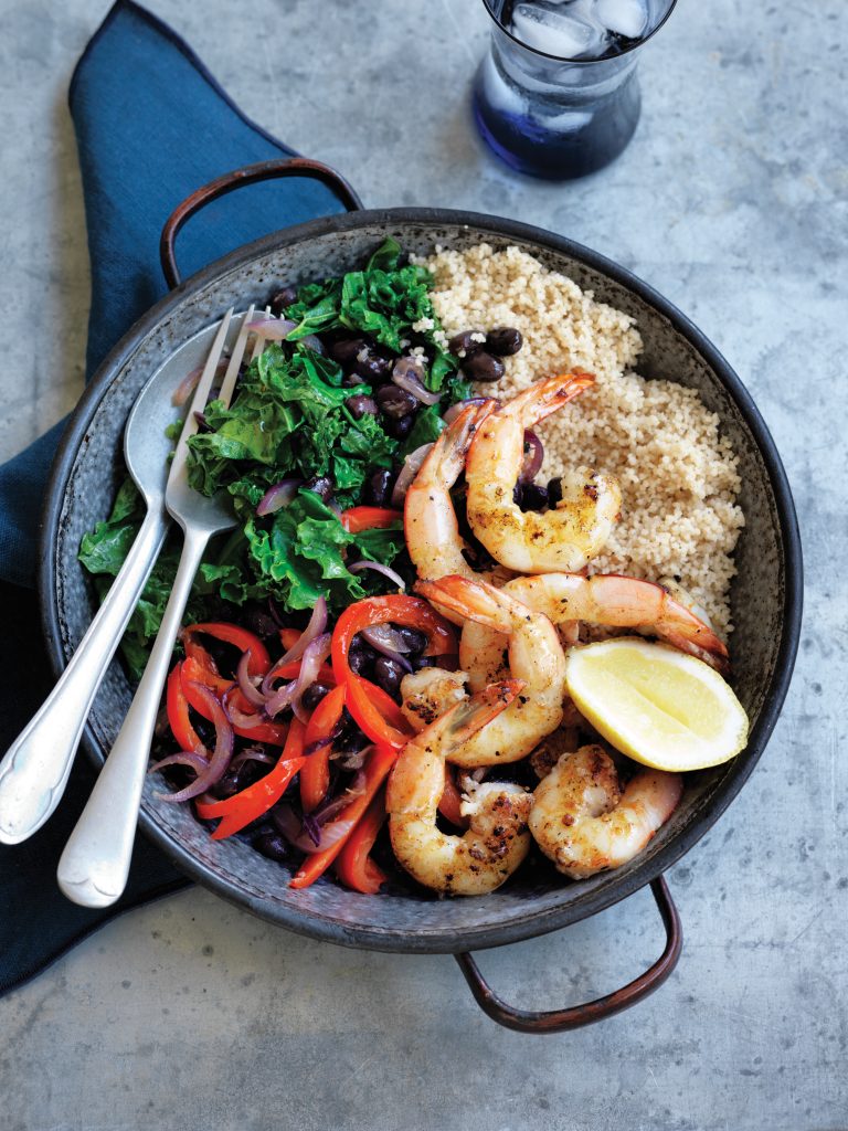 Warm black bean and kale couscous with grilled prawns