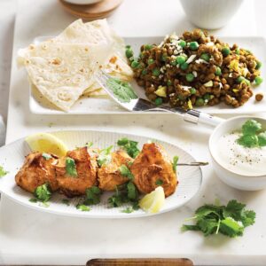 Tandoori chicken skewers with lentil, green pea and cauliflower dhal