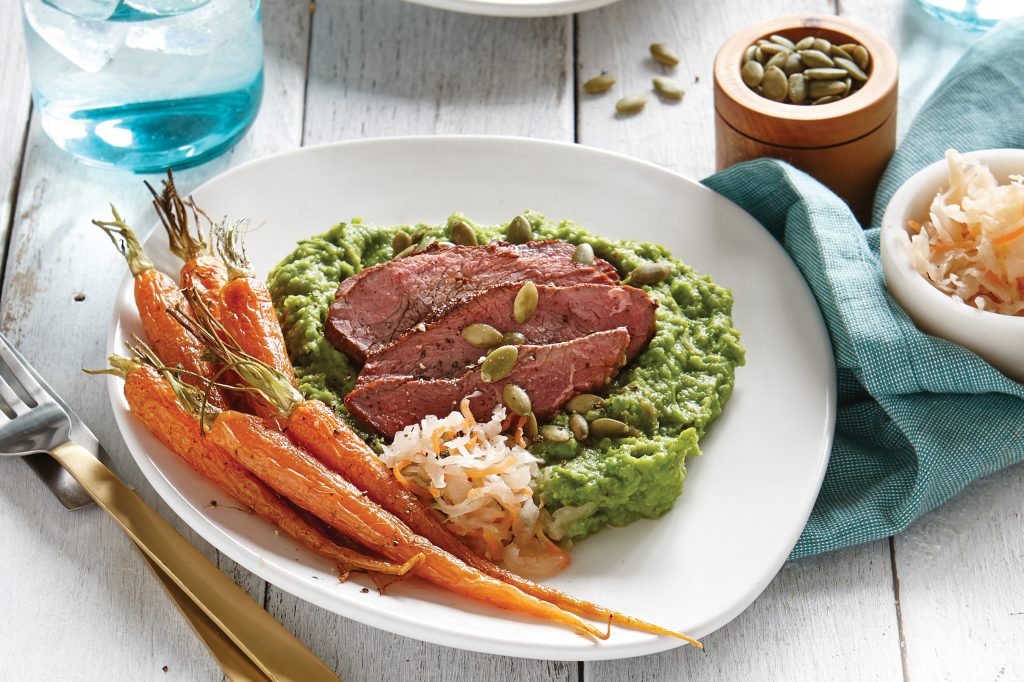 Lamb with broad bean purée and roasted baby carrots