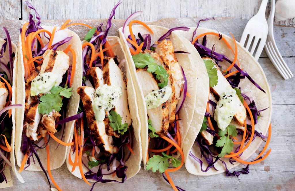 Spicy chicken tacos with slaw and avocado dressing