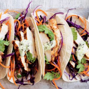 Spicy chicken tacos with slaw and avocado dressing