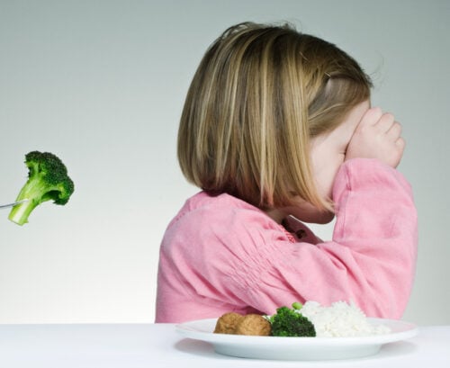 Girl refusing broccoli