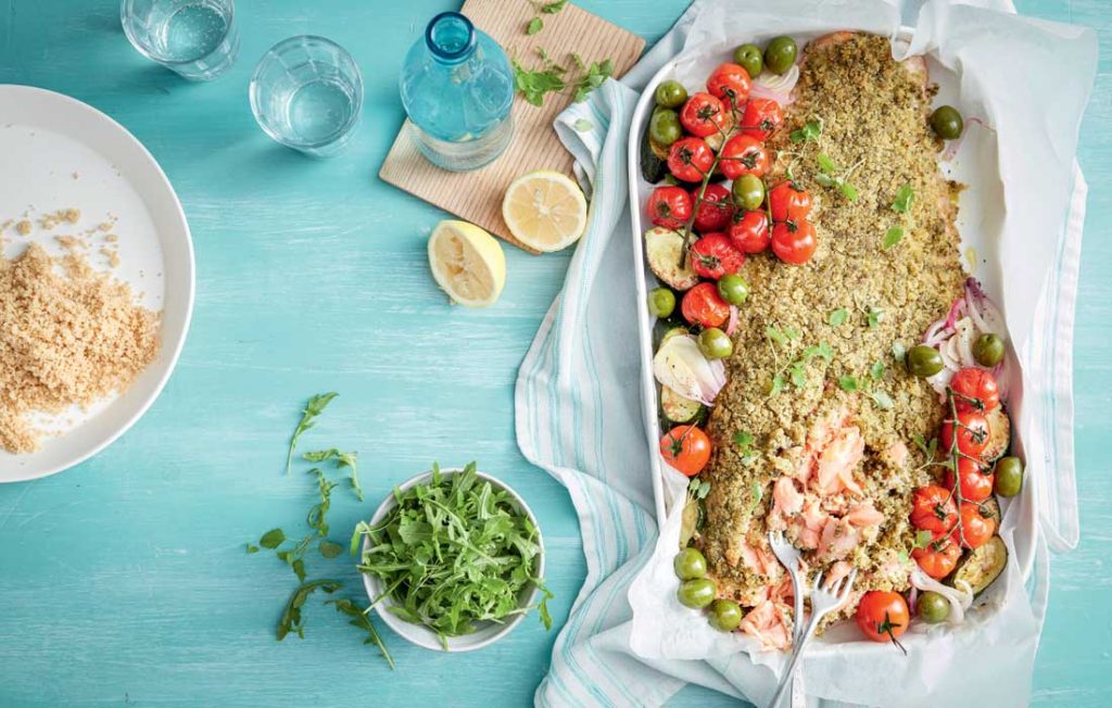 Pesto-crusted salmon with tomatoes and olives