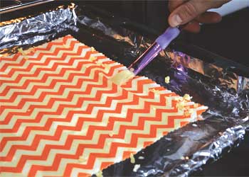 paimting melted beeswax onto fabric