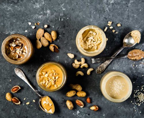four different types of nut butter in jars