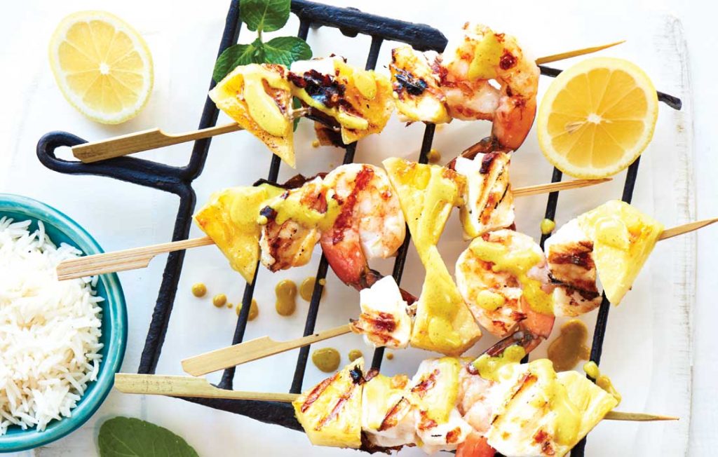 Seafood and pineapple skewers with coconut-curry sauce