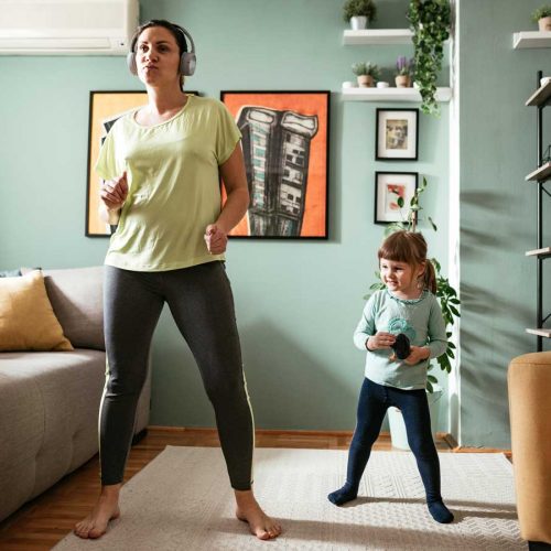 Mother and daughter exercising at home