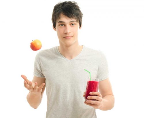 Man with apple and raw smoothie