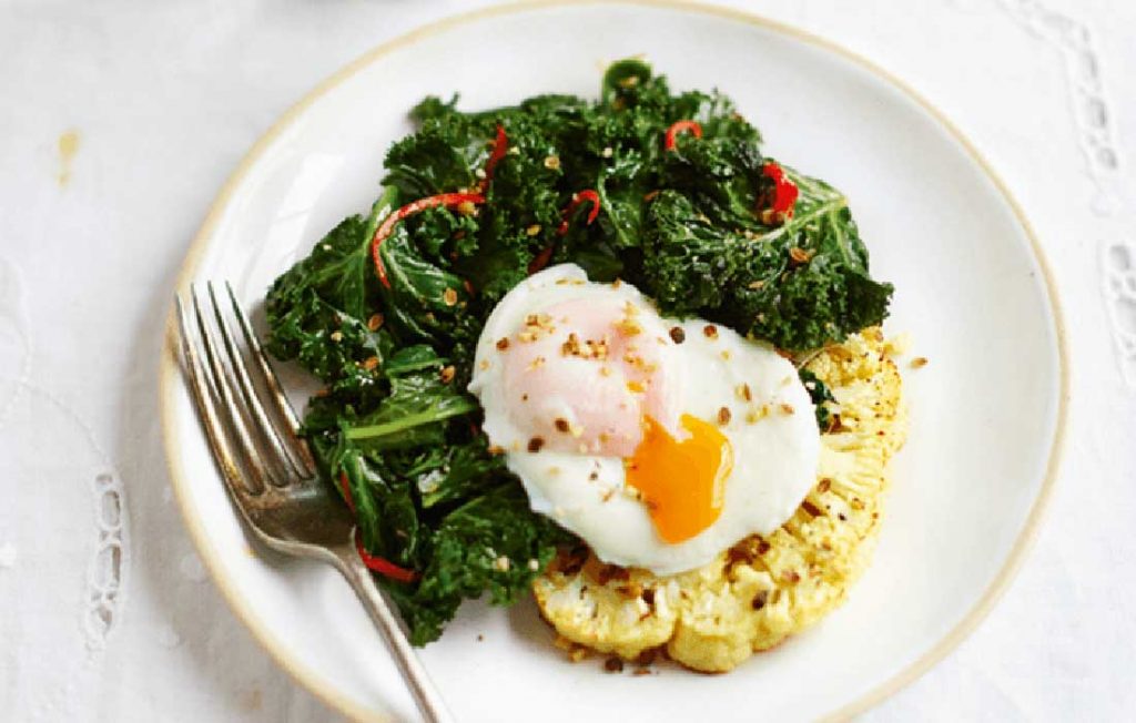 Poached eggs with cauliflower toasts, kale and dukkah