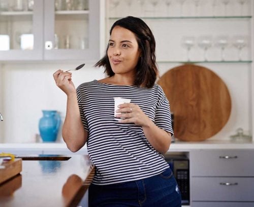 Woman eat probiotc yoghurt for gut health