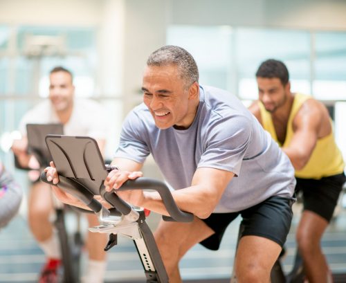 Man on stationary bike in spin class