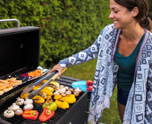 Woman barbecuing vegetables