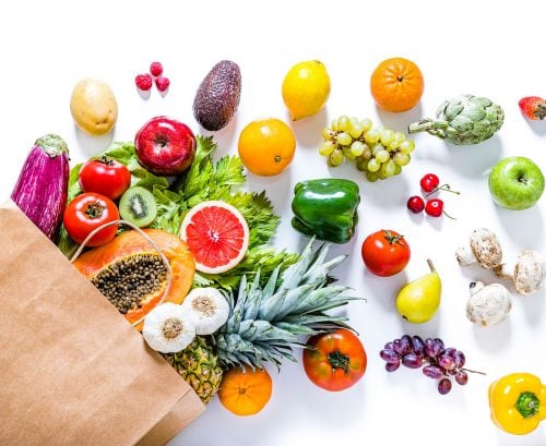 Grocery bag spilling an array of fruit and vegetables