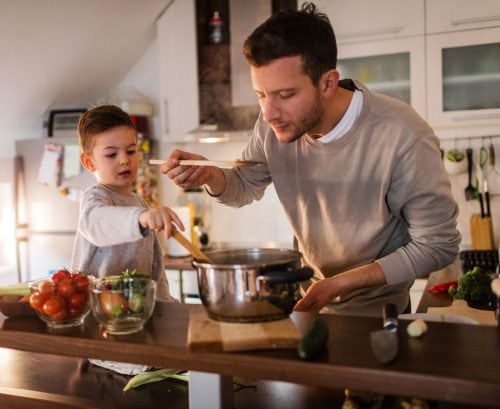 Man cooking with young son