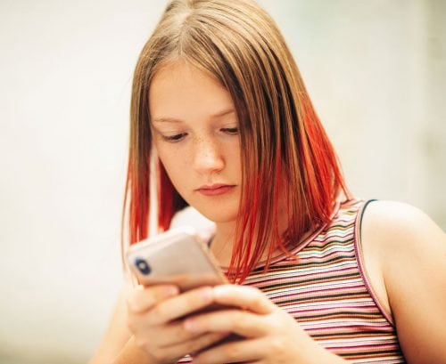 Adolescent girl looking at phone