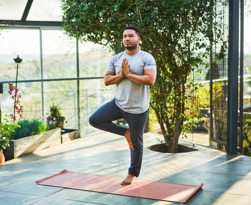 Man balancing on one leg doing yoga