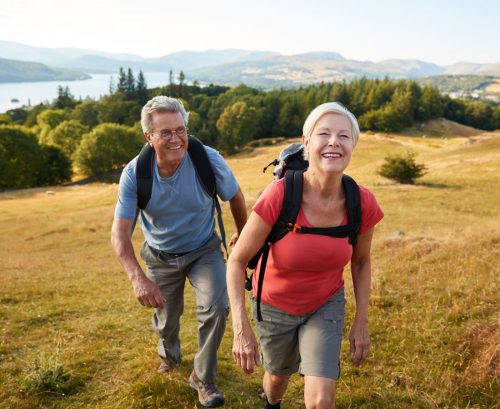 Energetic woman and man walking up a hill
