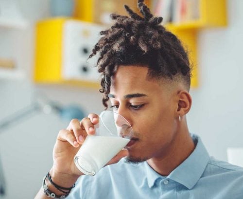 Young man drinking almond milk