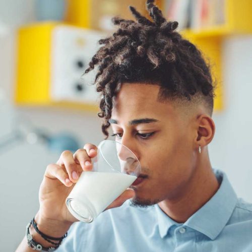 Young man drinking almond milk