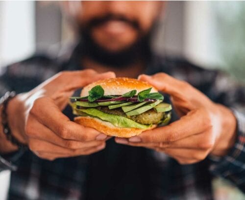 Man holding a vegetarian burger