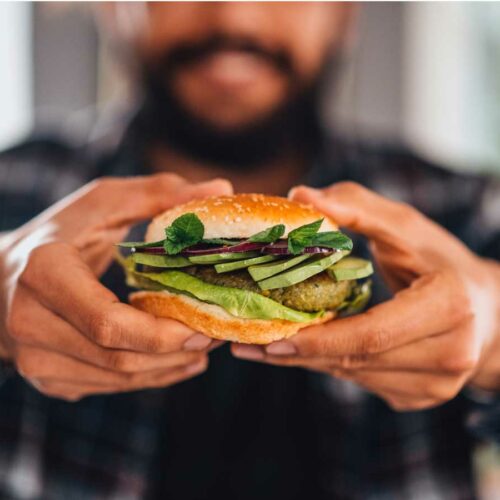 Man holding a vegetarian burger
