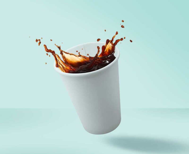 cup of coffee against a pastel blue background
