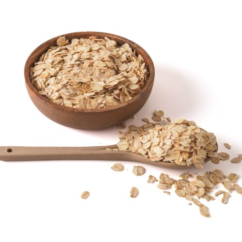 Gluten free wholegrain oat flakes in wooden bowl. - gluten-free swaps