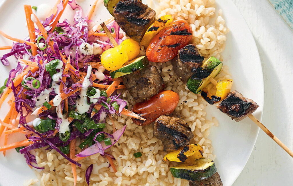 Charred vegetable and beef skewers with slaw